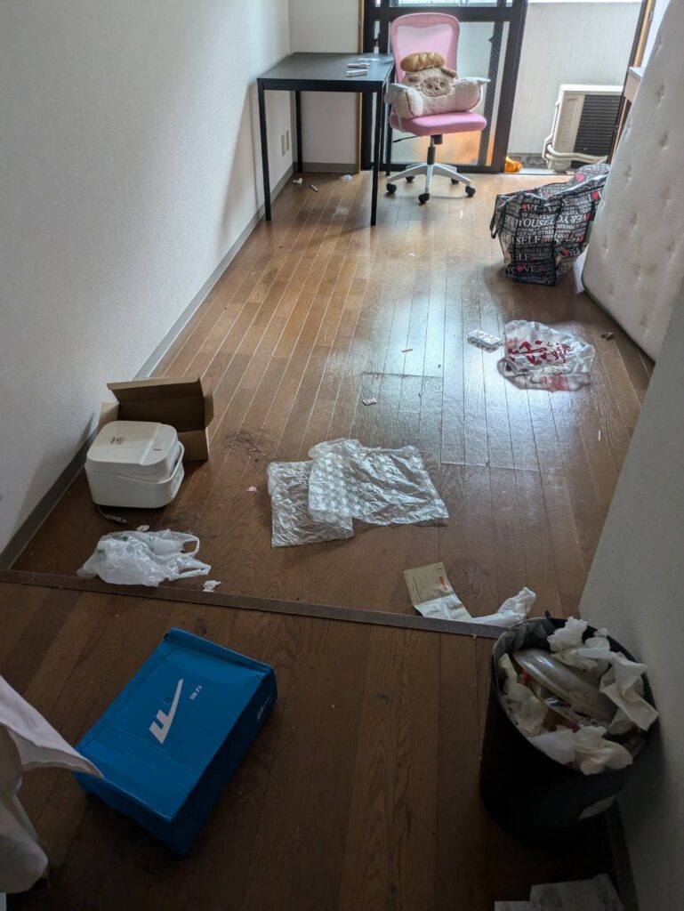 作業前：床に袋や小物が散らばったお部屋